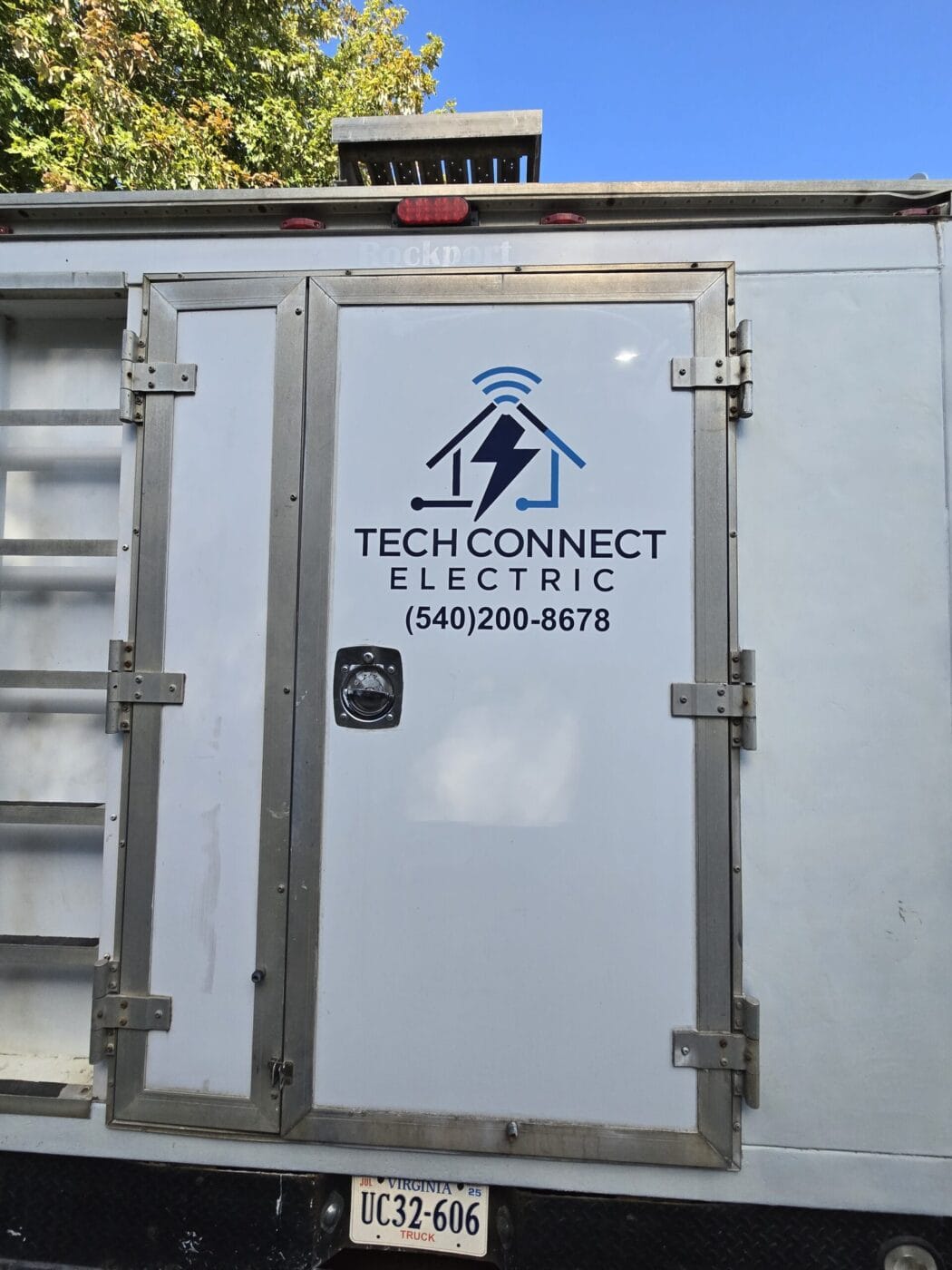 Back of a truck displaying the logo and contact information for 